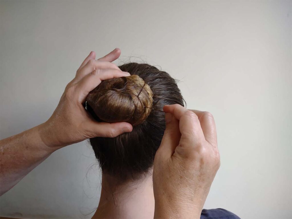 tying a ballet bun